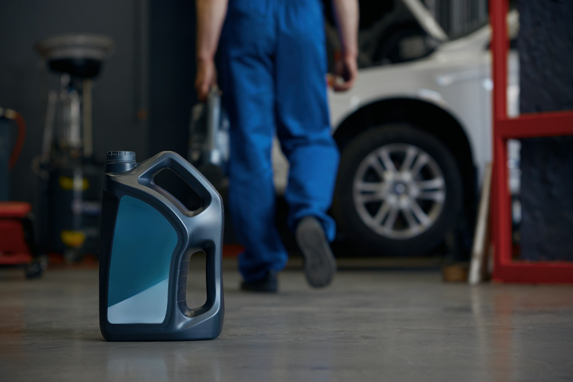 Closeup selective focus on engine oil canister over car repair center interior